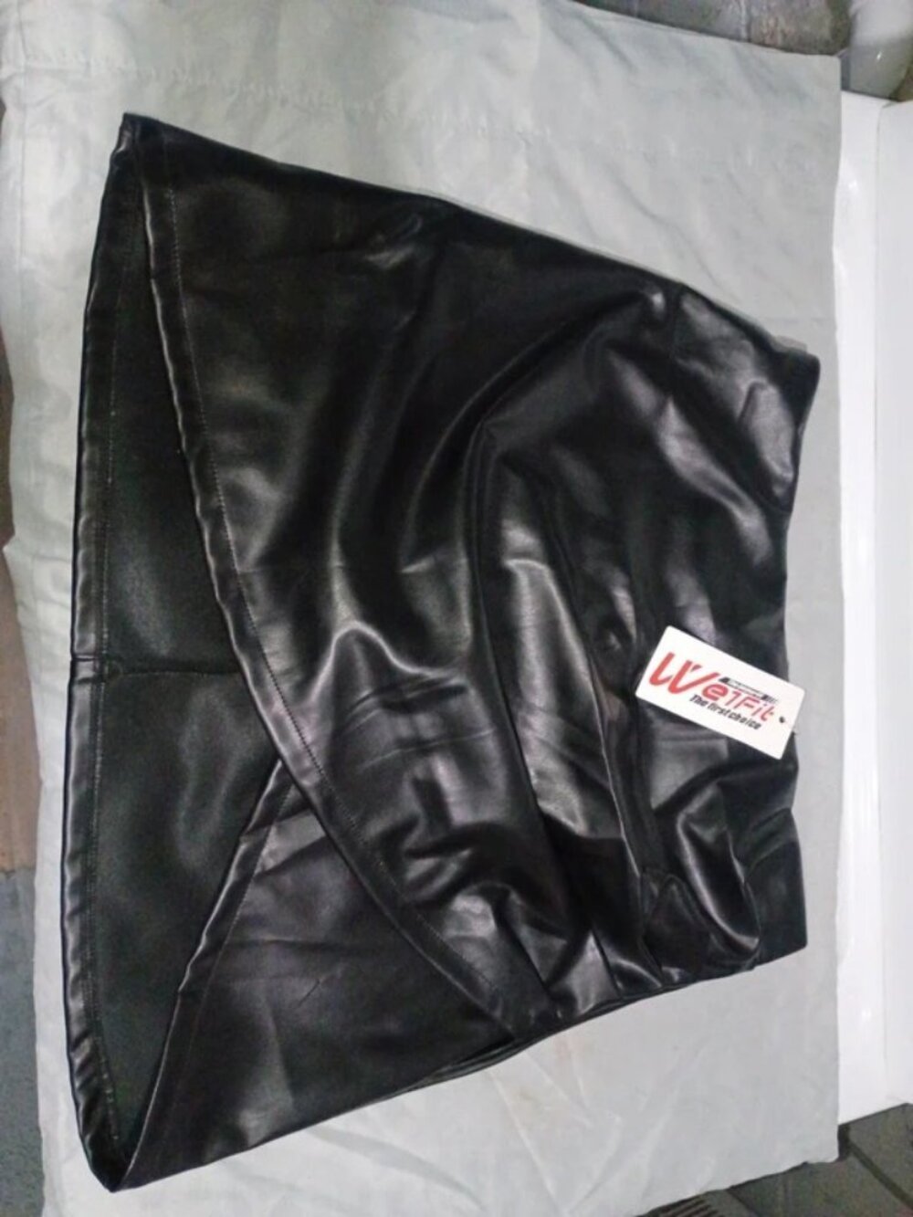 WE1FIT black faux leather mini wrap skirt